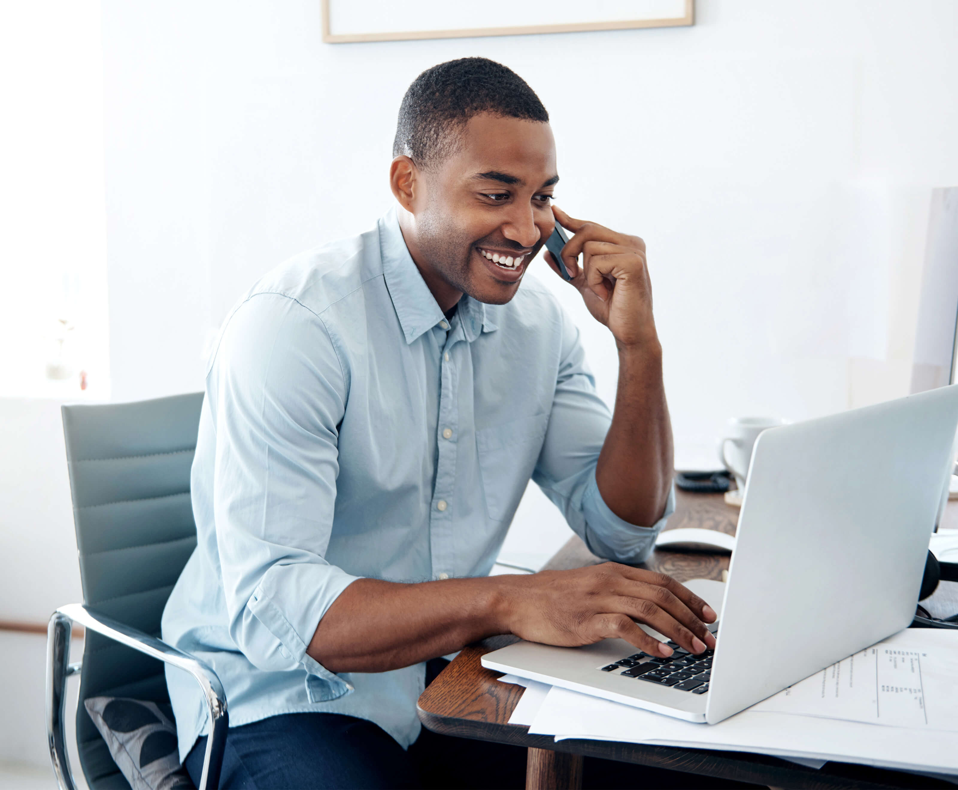 Man on the phone and on his computer in an office