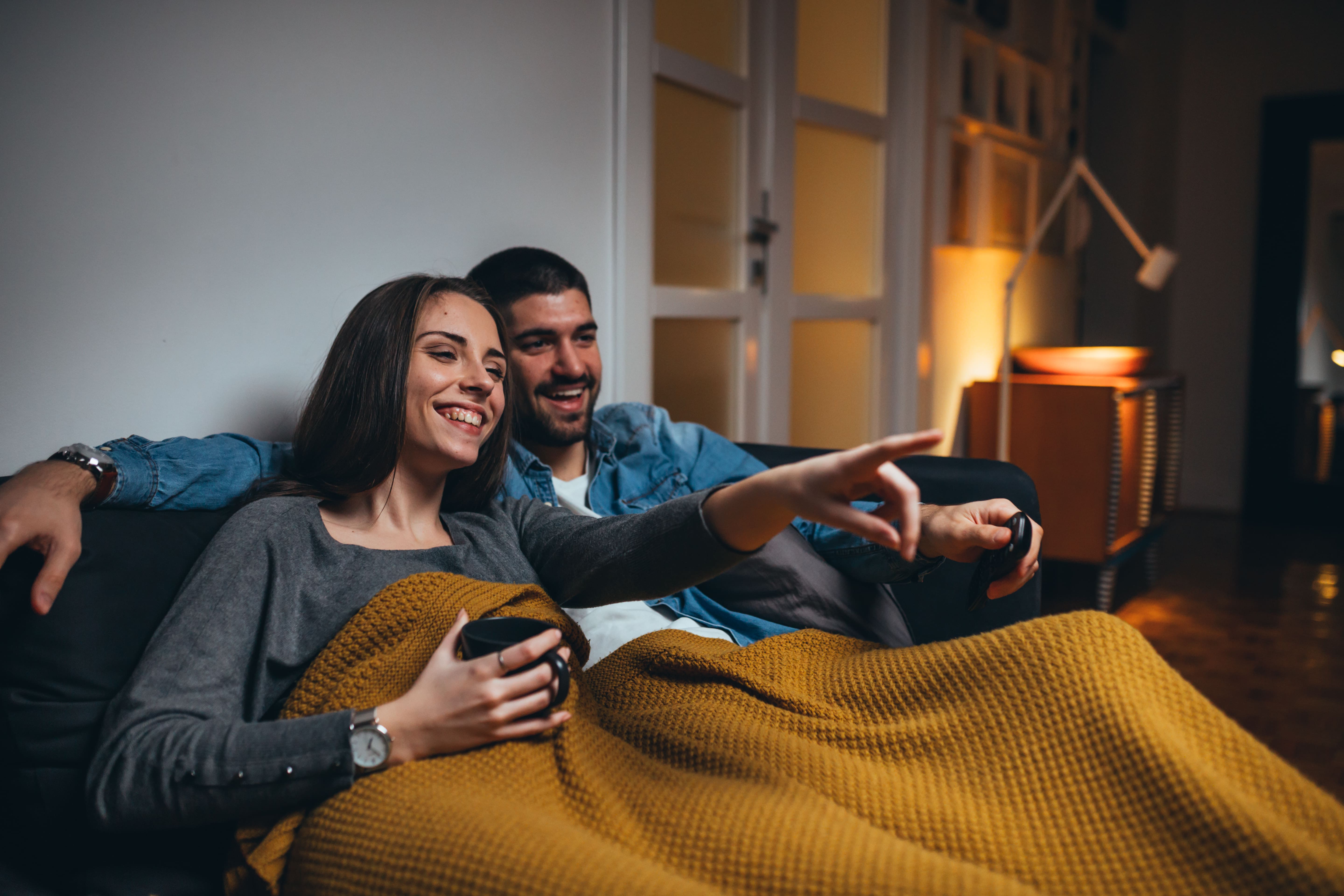 couple watching tv on couch