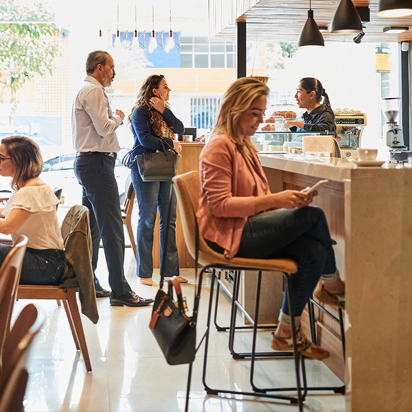 people on devices in a restaurant